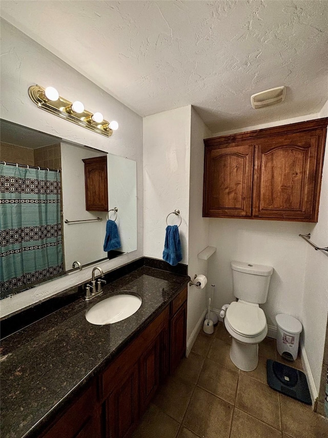 full bathroom featuring visible vents, toilet, vanity, a textured ceiling, and tile patterned flooring