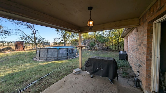 view of yard featuring fence and an outdoor pool