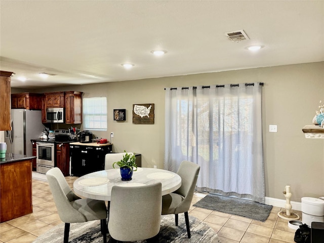 dining space featuring visible vents, baseboards, and light tile patterned floors