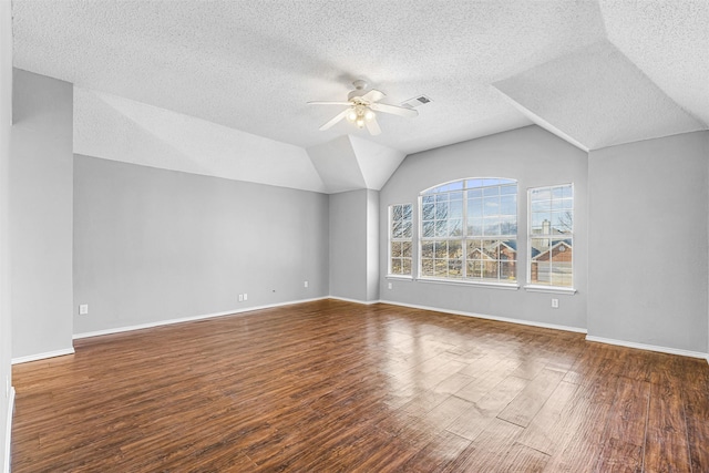 bonus room with vaulted ceiling, ceiling fan, a textured ceiling, and dark hardwood / wood-style floors