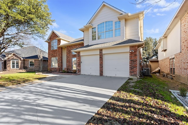 view of front of property featuring central air condition unit, a front lawn, and a garage