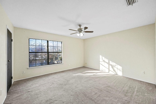 spare room featuring ceiling fan and carpet floors