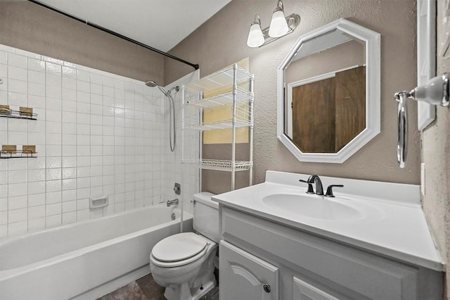 full bathroom with toilet, tiled shower / bath combo, and vanity