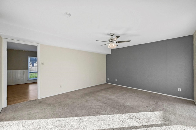 carpeted spare room with ceiling fan