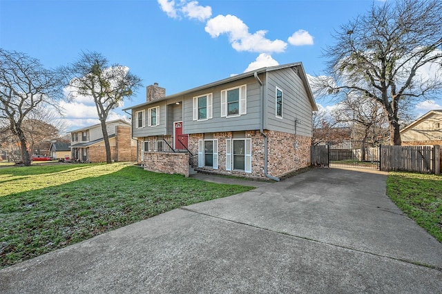 split foyer home with a front lawn