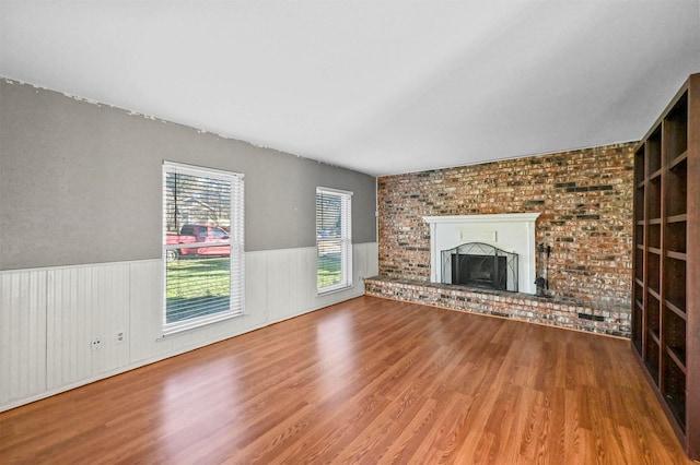 unfurnished living room with a fireplace and hardwood / wood-style floors