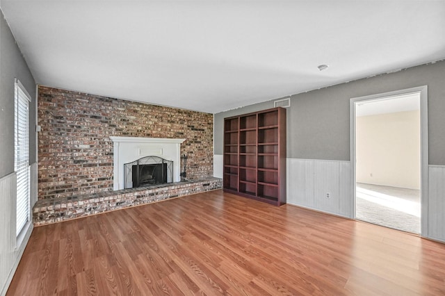 unfurnished living room featuring light hardwood / wood-style floors and a fireplace