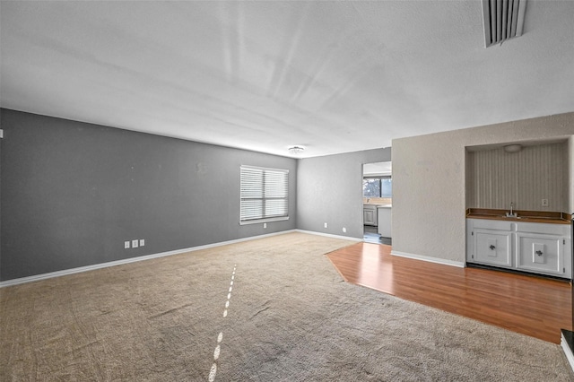 unfurnished living room with carpet floors