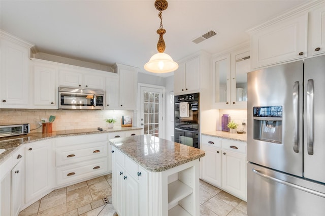 kitchen with decorative light fixtures, backsplash, white cabinets, and black appliances