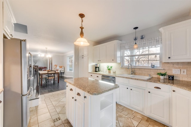 kitchen featuring sink, white cabinetry, appliances with stainless steel finishes, and a kitchen island