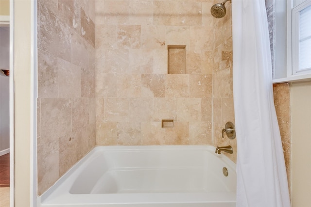 bathroom featuring shower / bath combo with shower curtain