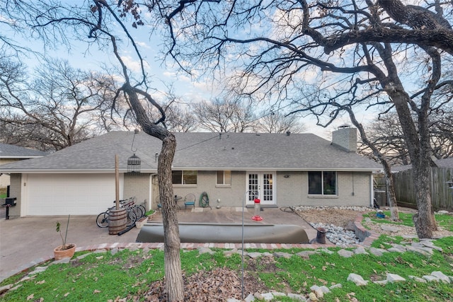 back of house featuring a patio area and a garage