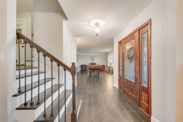 foyer entrance with dark hardwood / wood-style floors