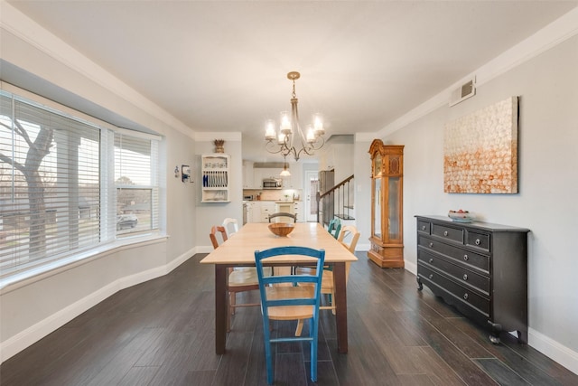 dining room featuring a chandelier, crown molding, and dark hardwood / wood-style flooring