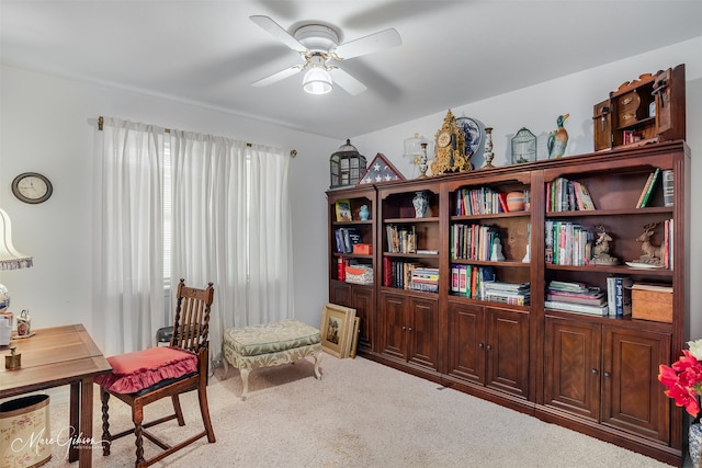 living area featuring carpet and ceiling fan