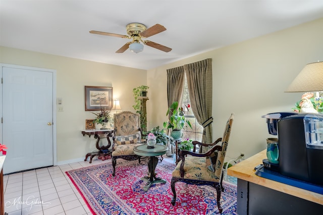 living area with ceiling fan and light tile patterned floors