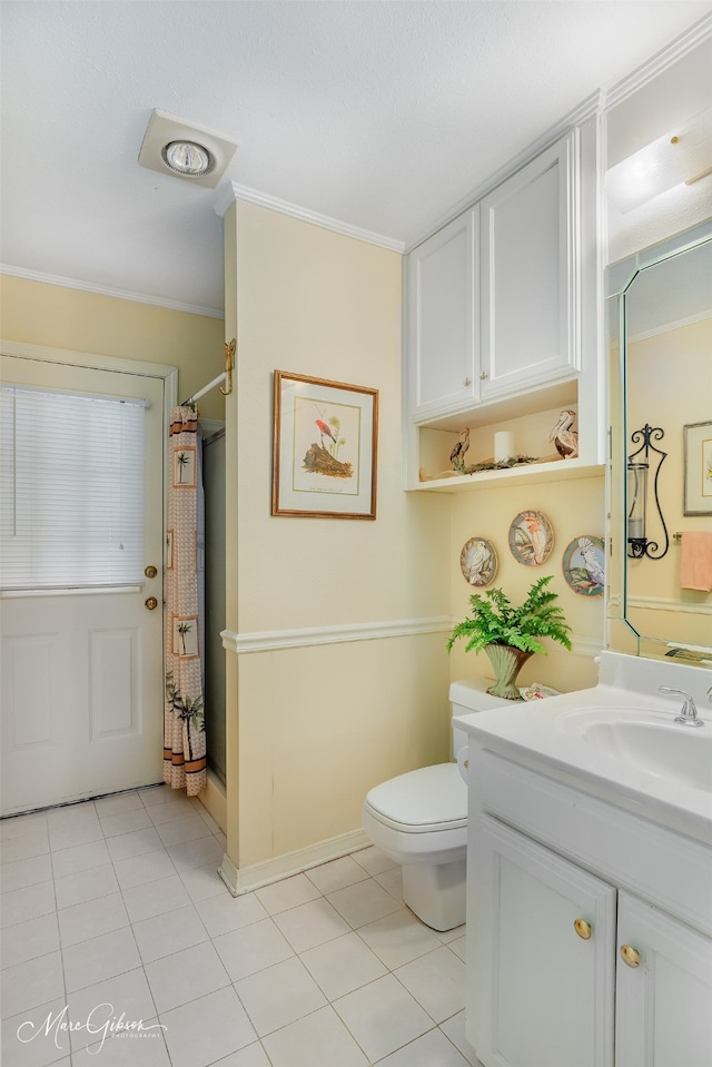 bathroom featuring toilet, walk in shower, ornamental molding, and vanity