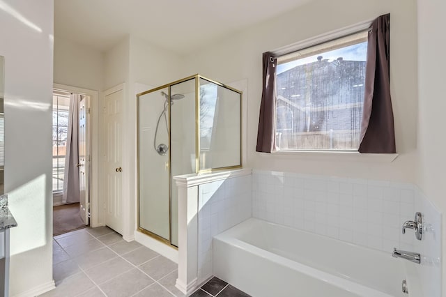 bathroom with tile patterned flooring, shower with separate bathtub, and plenty of natural light