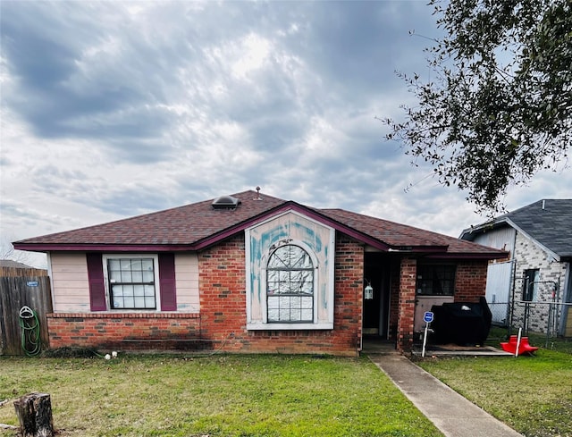 ranch-style house with a front lawn