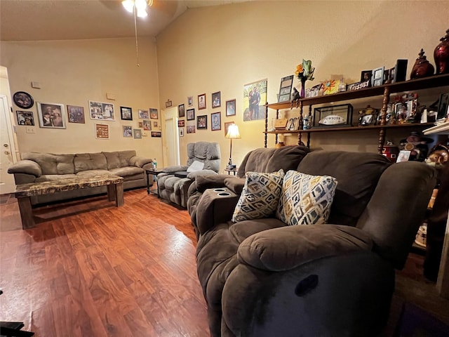 living room with hardwood / wood-style flooring, lofted ceiling, and ceiling fan