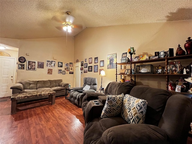 living room featuring ceiling fan, a textured ceiling, lofted ceiling, and hardwood / wood-style floors