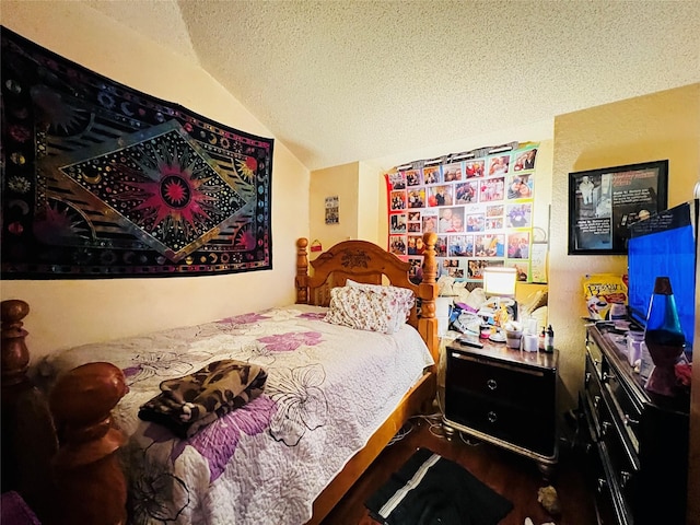 bedroom featuring vaulted ceiling and a textured ceiling