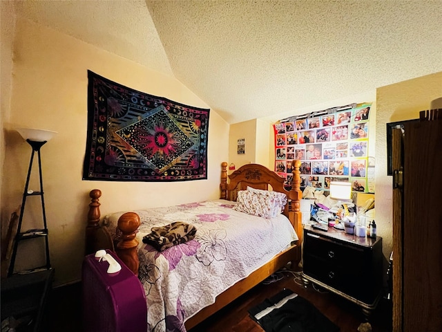 bedroom featuring a textured ceiling and lofted ceiling