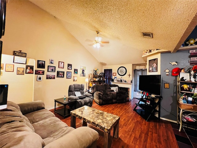 living room featuring a textured ceiling, ceiling fan, hardwood / wood-style floors, and high vaulted ceiling