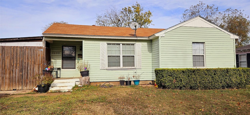 back of house with a lawn