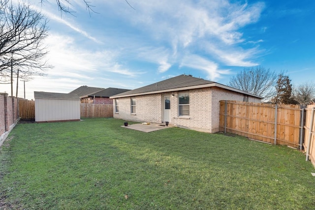 back of house with a shed, a lawn, and a patio