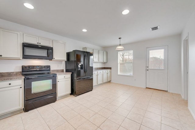 kitchen with black appliances, light tile patterned floors, decorative light fixtures, and white cabinetry