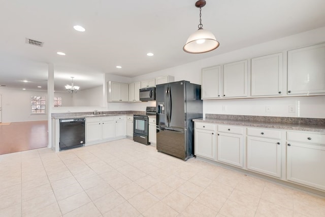 kitchen with pendant lighting, black appliances, sink, white cabinetry, and a chandelier