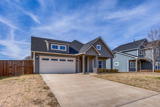 view of front of property with a garage, fence, concrete driveway, board and batten siding, and a front yard