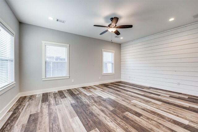 unfurnished bedroom with ceiling fan, a closet, and hardwood / wood-style floors