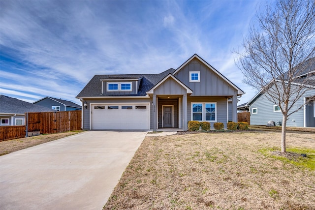 view of front of home with concrete driveway, roof with shingles, fence, board and batten siding, and a front yard