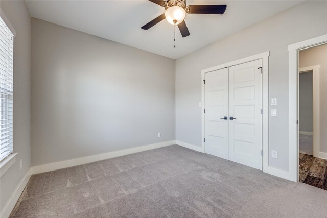 carpeted empty room with ceiling fan