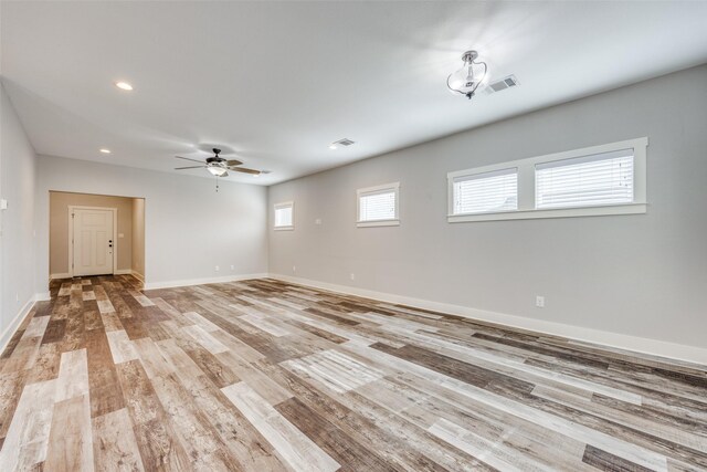 empty room with ceiling fan and hardwood / wood-style flooring