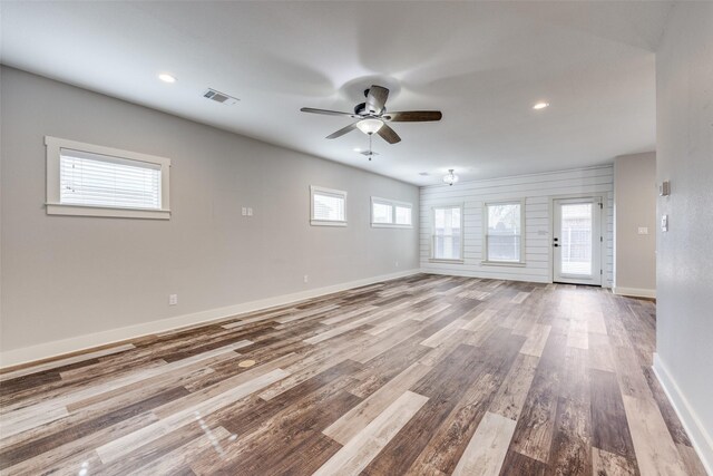 unfurnished living room featuring ceiling fan and light hardwood / wood-style flooring