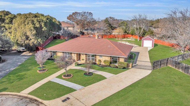 view of front of property featuring a garage, an outdoor structure, and a front lawn