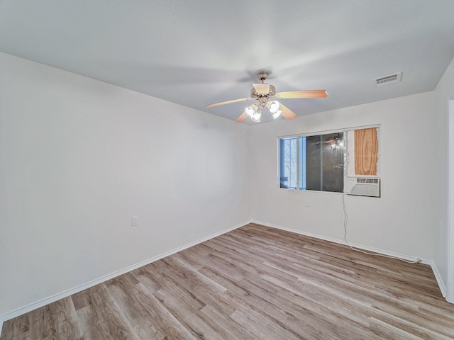 unfurnished room featuring ceiling fan, cooling unit, and light hardwood / wood-style flooring