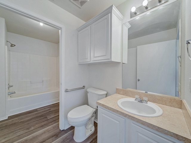 full bathroom featuring toilet, shower / tub combination, hardwood / wood-style floors, and vanity