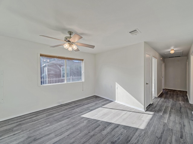 spare room with ceiling fan and dark wood-type flooring