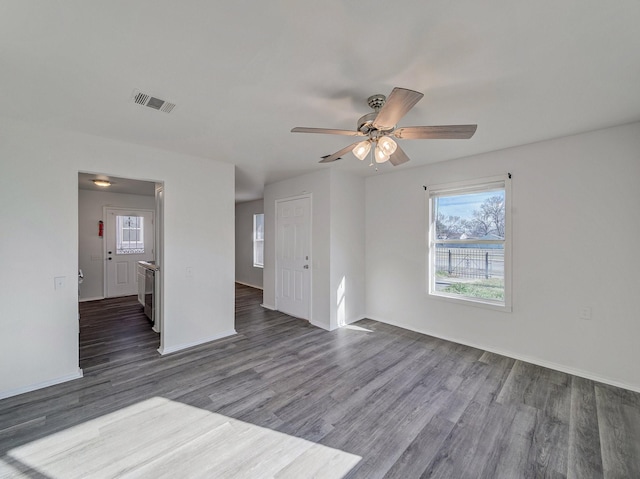 empty room with dark wood-type flooring and ceiling fan