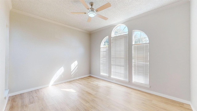 spare room featuring a textured ceiling, ceiling fan, crown molding, and light wood-type flooring