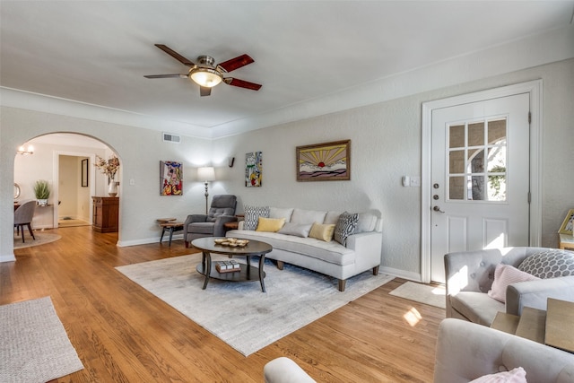 living room featuring ceiling fan and light wood-type flooring