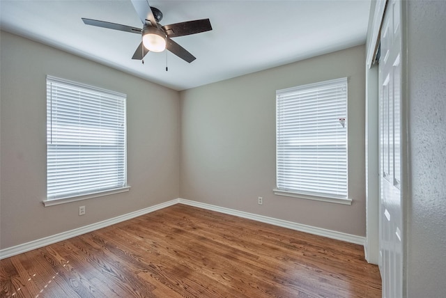 unfurnished room with ceiling fan and wood-type flooring