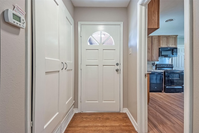 entryway with light hardwood / wood-style floors