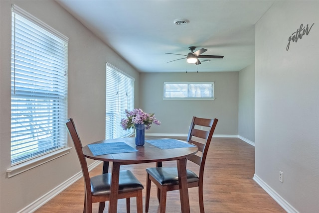 dining space featuring light hardwood / wood-style flooring and ceiling fan