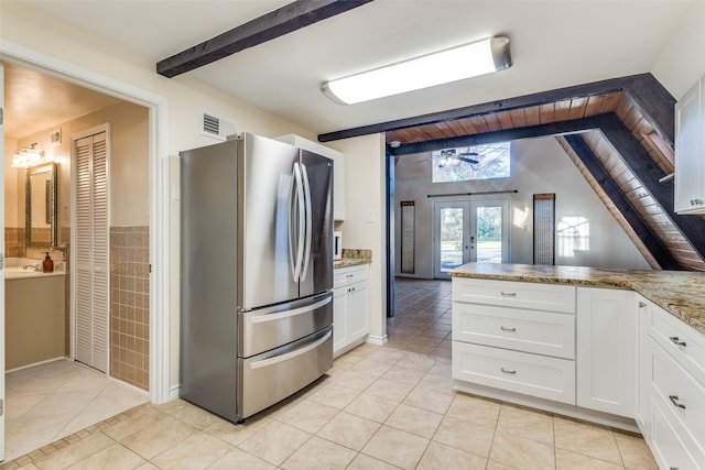 kitchen featuring light tile patterned floors, white cabinetry, stainless steel fridge, ceiling fan, and french doors