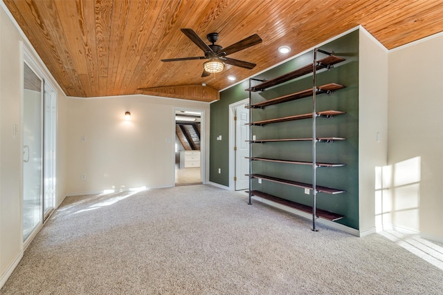 carpeted spare room with ceiling fan and wood ceiling